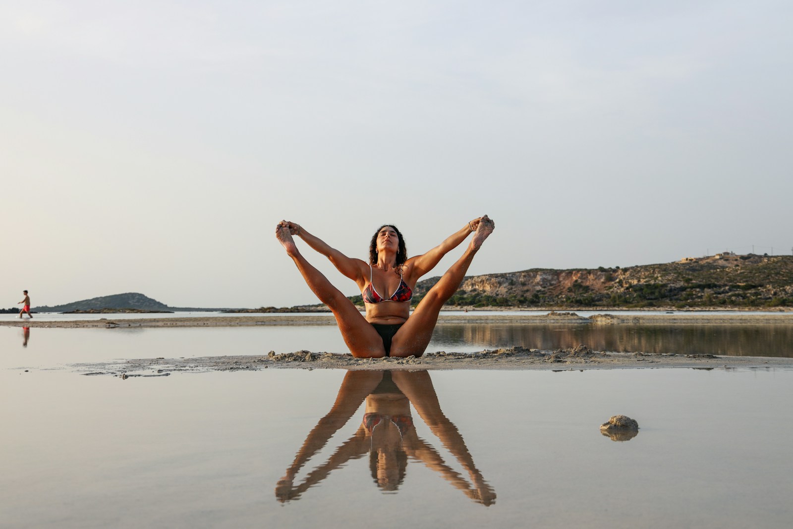 a woman stretching on beach, yeast infection