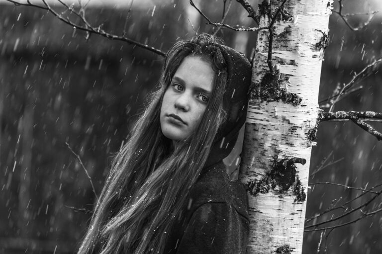 grayscale photo of woman in black coat